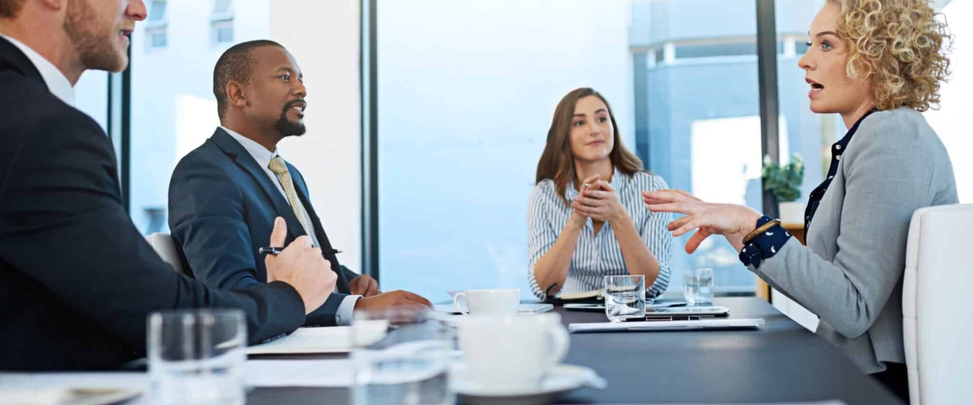 business-group-talking-boardroom-meeting-company-ideas-planning-team-people-office-with-strategy-brainstorming-pitch-corporate-leadership-new-york-city-usa Business, group and talking in boardroom for meeting at company, ideas or planning. Team, people and office with strategy or brainstorming for pitch, corporate leadership in New York City or USA.